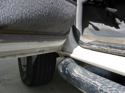 1994 Ford Bronco - The interior of a vehicle is shown, focusing on the door sill and running board area.