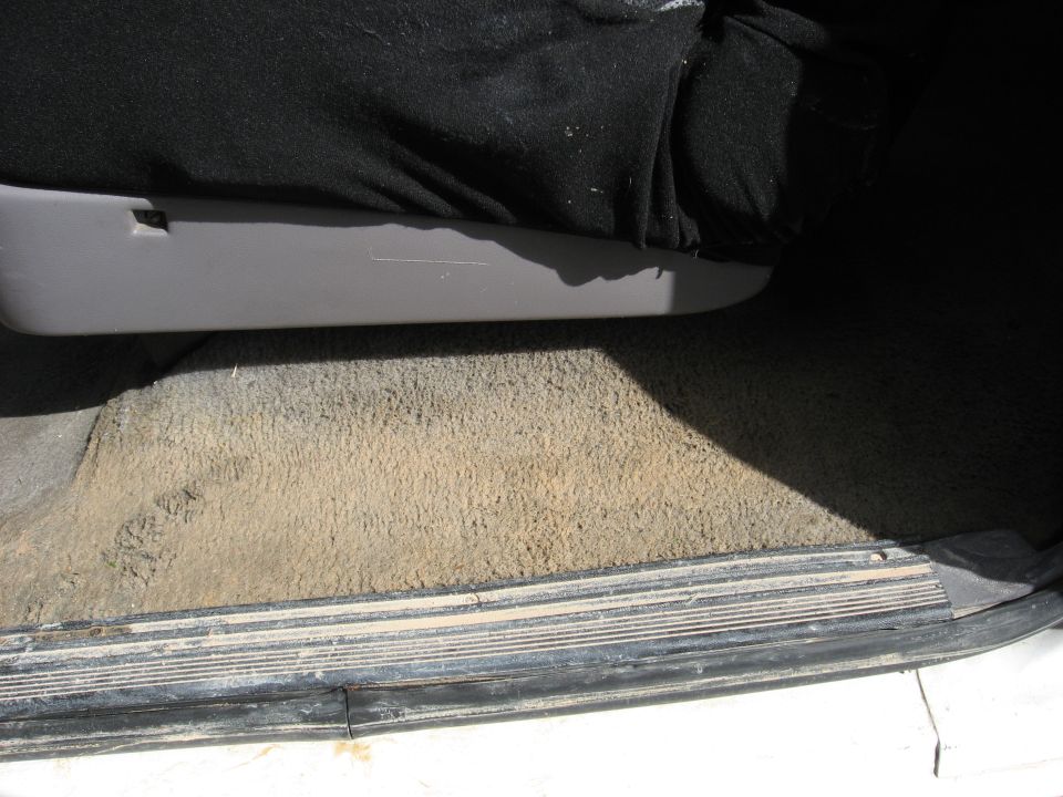 Interior door sill and dirty carpet of a vehicle