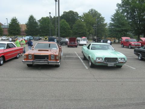 1972 Ford Ranchero - A light green 1972 Ford Ranchero is parked in a lot, facing forward, with another car to its left.