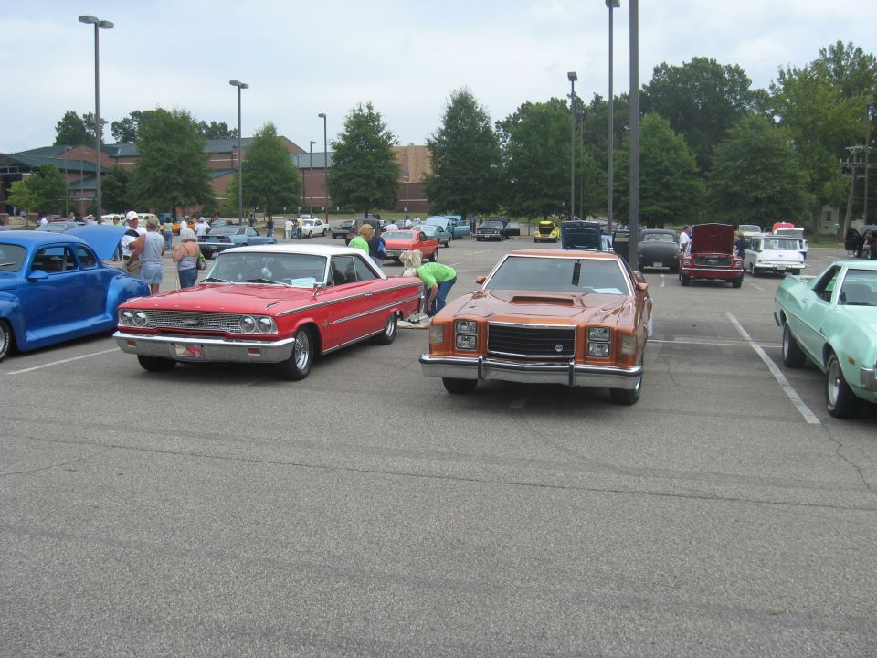 Orange coupe with hood scoop, front view