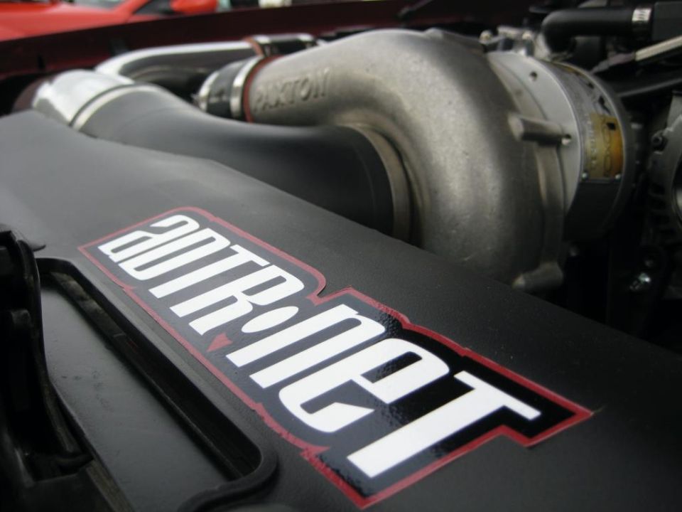 Engine bay with Paxton supercharger and a sticker reading 20TR.net