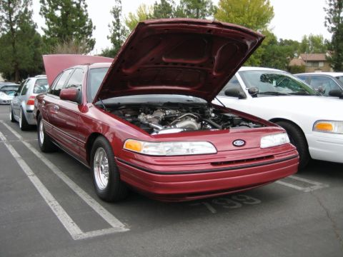 1992 Ford Crown Victoria - Red 1992 Ford Crown Victoria with hood open, parked next to a white Crown Victoria.