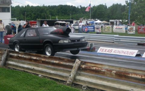 1990 Ford Mustang - A modified 1990 Ford Mustang sits on the drag strip, ready for a race.