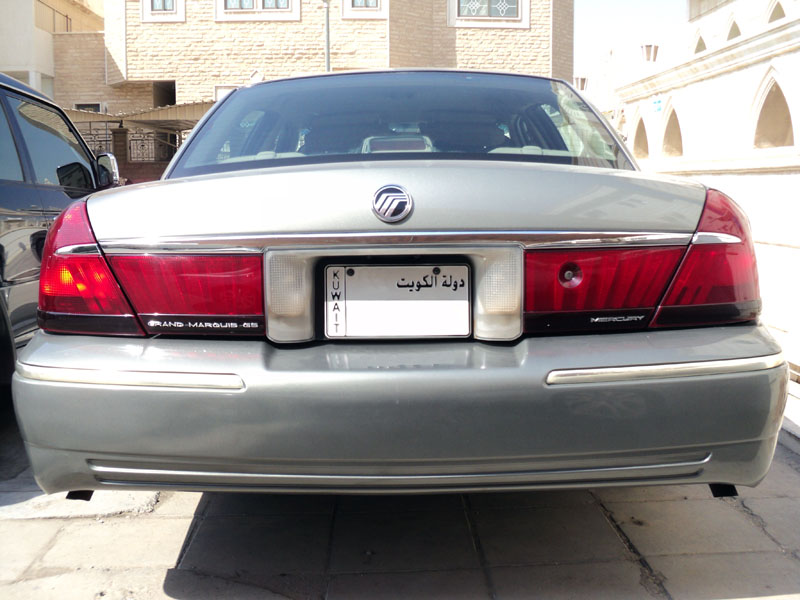 Rear of silver-green Mercury Grand Marquis GS with tucked bumper and Kuwait plate