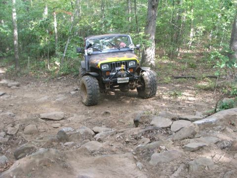 1996 Ford Bronco - A modified Jeep Wrangler navigates a challenging off-road course.