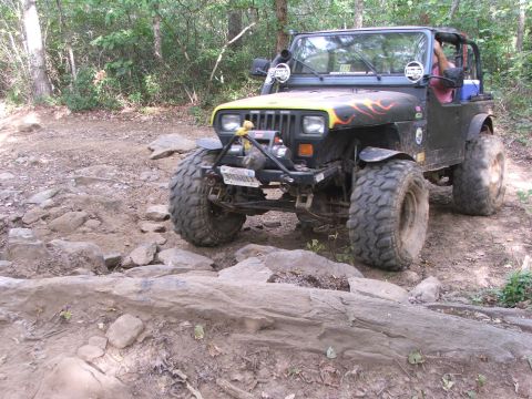 1996 Ford Bronco - This modified Jeep Wrangler navigates a challenging rocky trail, its off-road capabilities.