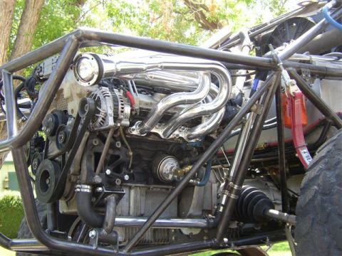 1993 Ford Taurus - Custom engine bay with chrome headers and a prominent roll cage structure.