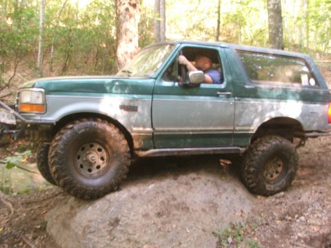 1996 Ford Bronco - This 1996 Ford Bronco is navigating a rocky obstacle on an off-road trail.
