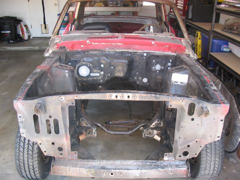 1968 Ford Mustang - This car chassis, likely a 1967 model, is in a state of disassembly and shows significant rust and missing parts.