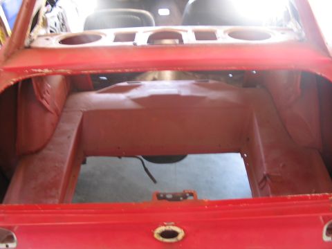 1968 Ford Mustang - Interior view of a 1968 Ford Mustang trunk, showing structural components and red paint.