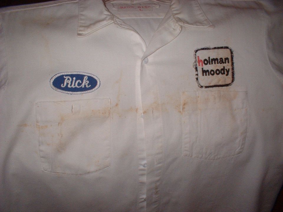White work shirt with blue 'Rick' oval patch and black square 'holman moody' patch. Stains visible on fabric