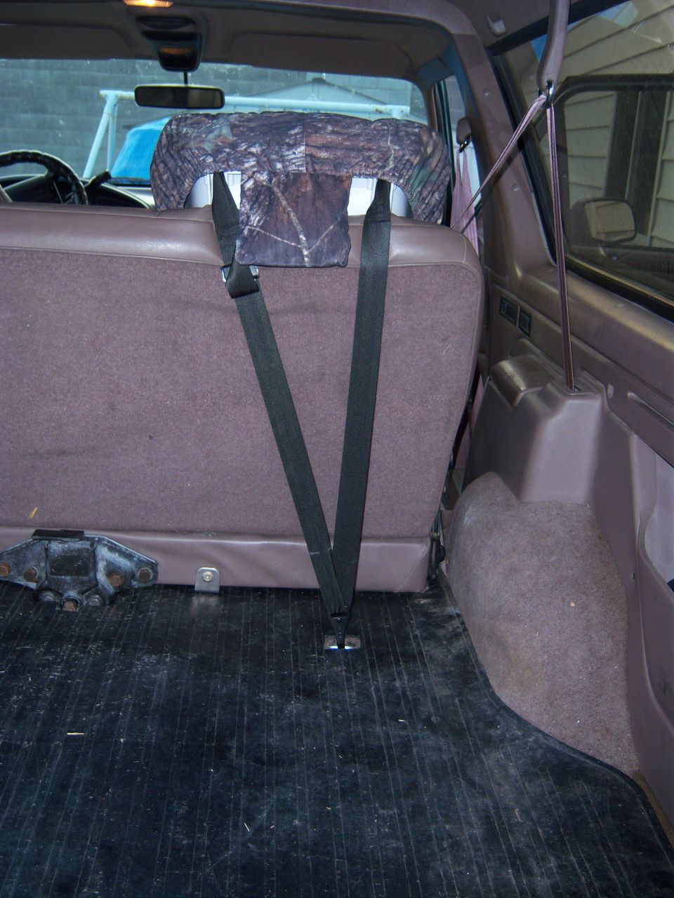 Rear seat and cargo area of a 1996 Ford Bronco. Shows seatbelts and seat covers