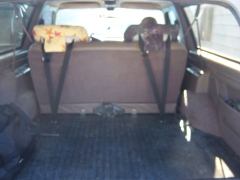 1996 Ford Bronco - Rear cargo area of a 1996 Ford Bronco, showing seat belts and floor.