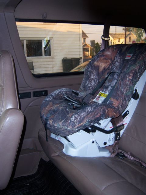 1996 Ford Bronco - Interior view of a vehicle showing a child seat with a camouflage cover.