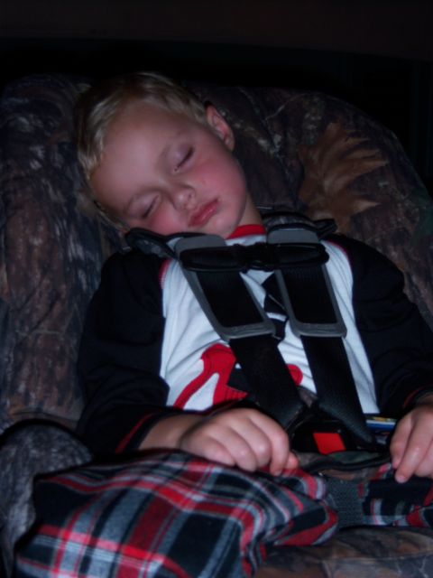 1996 Ford Bronco - Child sleeping in a car seat, likely in a vehicle's interior.