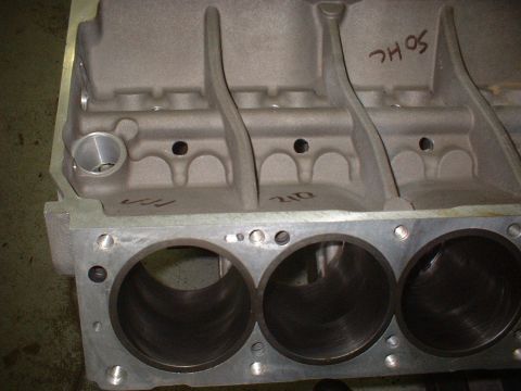 1965 Shelby Cobra - This is a close-up view of an engine block, showing the cylinder bores and internal structure. Text is visible on the surface.