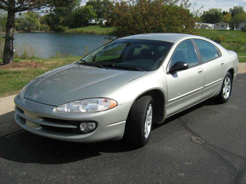 Silver sedan parked by a lake