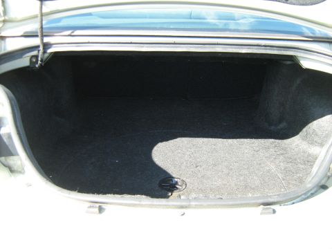 1988 Mercury Grand Marquis - The trunk of a 1988 Mercury Grand Marquis is shown, with carpeting and a drain plug visible.
