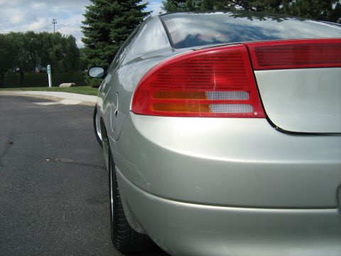 1988 Mercury Grand Marquis - The rear of a silver Dodge Intrepid is shown from a low angle, focusing on the taillight and bumper.