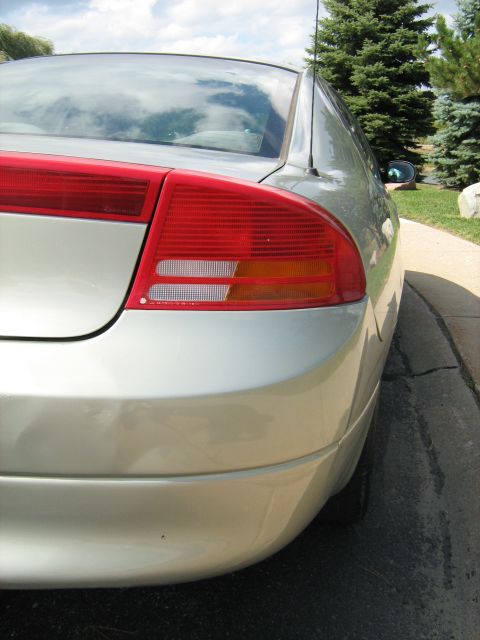 1988 Mercury Grand Marquis - Rear view of a silver sedan, focusing on the taillight assembly and body lines.