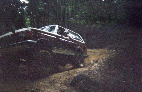 1990 Ford Bronco - This 1990 Ford Bronco navigates a challenging muddy terrain, its off-road capabilities.