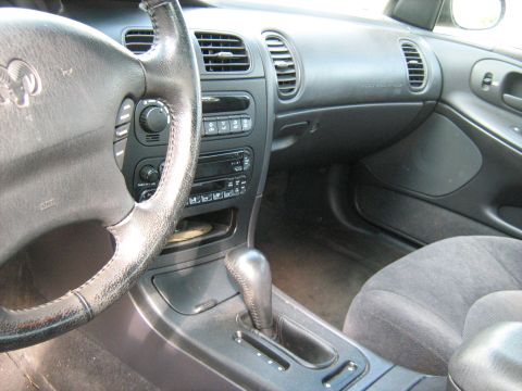 1988 Mercury Grand Marquis - The interior of a Dodge Intrepid features a gray cloth seat and a black dashboard with a CD player and air vents.