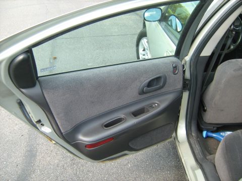 1988 Mercury Grand Marquis - The interior door panel of a car is shown, with a reflection of another vehicle visible in the window.