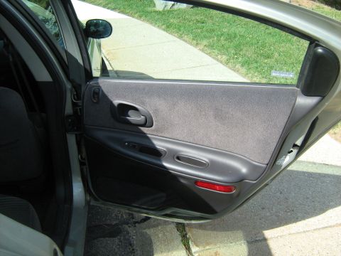 1988 Mercury Grand Marquis - View of the interior door panel and window of a car.
