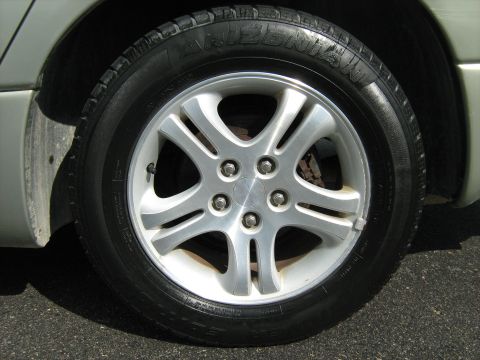 1988 Mercury Grand Marquis - Close-up of a car's wheel and tire, showing the tread pattern and alloy rim.