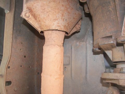 1995 Ford Bronco - Undercarriage view shows a rusty exhaust pipe and transmission housing, with visible text from SUPERMOTORS.NET.