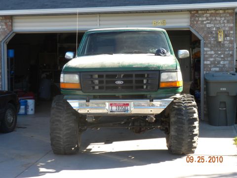 1989 Ford Bronco - This lifted 1992 Ford F-150 features a prominent grille and massive off-road tires, giving it a commanding presence.