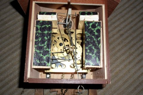 1978 Ford Bronco - The intricate mechanical workings of a cuckoo clock, brass gears, chains, and escapement mechanism.