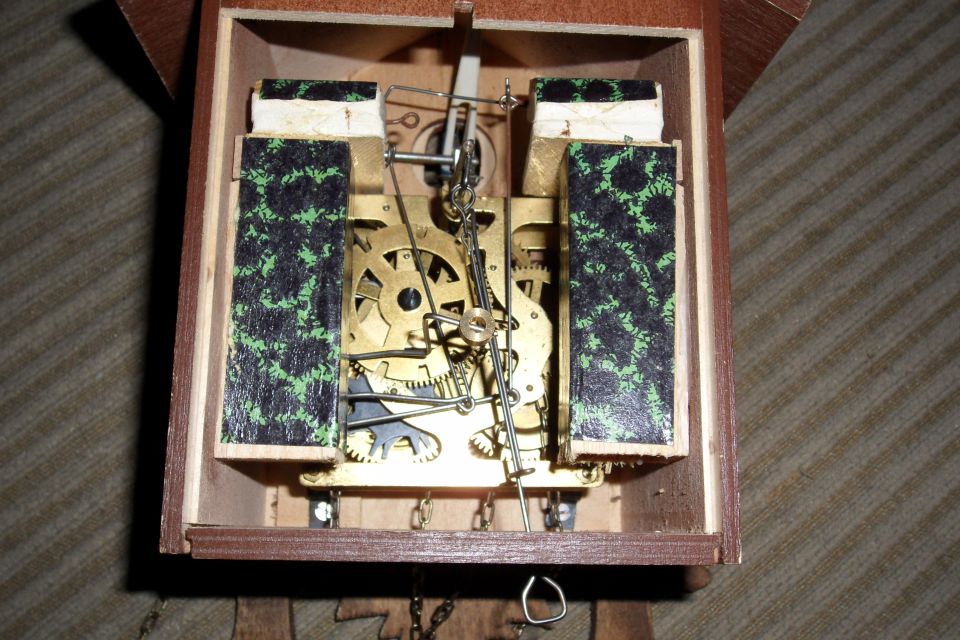 Cuckoo clock mechanism with brass gears and chains