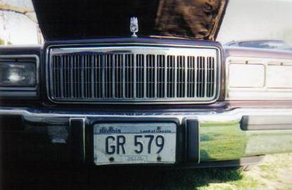 1990 Mercury Grand Marquis - Front view of a 1990 Mercury Grand Marquis, showing its distinctive grille and license plate.