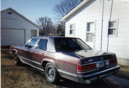 1990 Mercury Grand Marquis - Rear view of a brown Mercury Grand Marquis parked in a driveway.