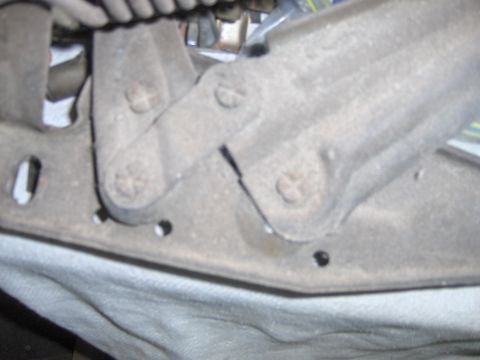1970 Chevrolet Camaro - Close-up of the hood hinge mechanism on a 1970 Chevrolet Camaro, revealing signs of age and use.