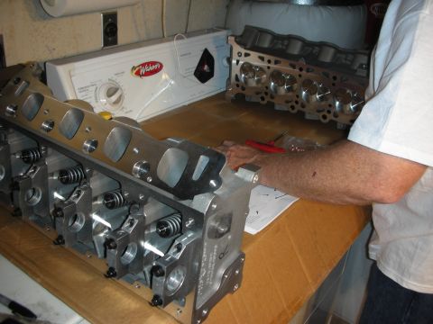 1992 Ford Crown Victoria - Engine cylinder heads are laid out on a workbench, possibly for a rebuild or modification.