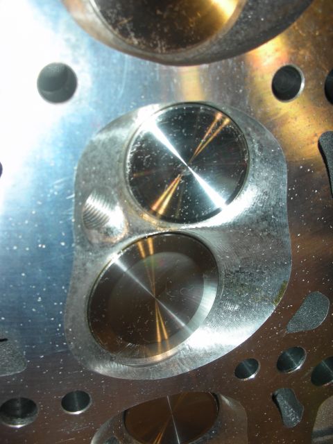 1992 Ford Crown Victoria - This image shows a close-up view of an engine's cylinder head, focusing on the valves and the machined metal surfaces.