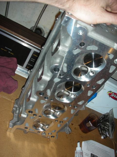 1992 Ford Crown Victoria - An aluminum engine cylinder head with multiple ports and valves is shown from a close-up perspective.