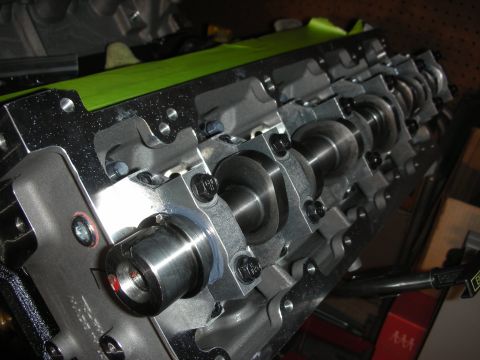 1992 Ford Crown Victoria - Close-up view of an engine block camshafts and roller rockers, with green tape applied to the surface.