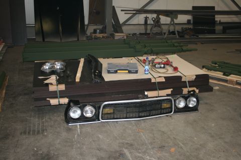 1973 Ford Ranchero - Front end parts for a 1973 Ford Ranchero are laid out on the floor with a toolbox.