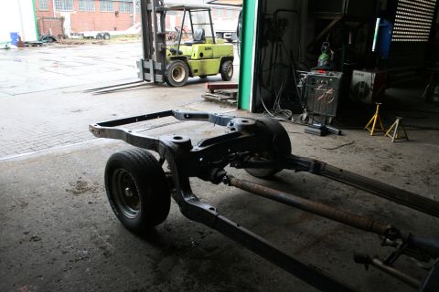 1973 Ford Ranchero - A vehicle frame is shown in a workshop, with a forklift visible in the background.