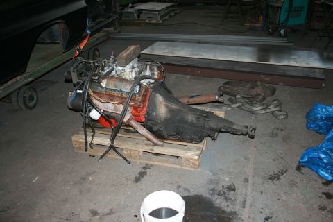 1973 Ford Ranchero - An engine and transmission assembly rests on a pallet in a workshop environment.