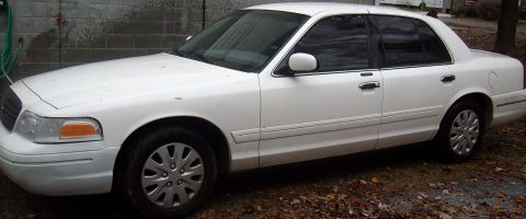 2002 Ford Crown Victoria - A white 2002 Ford Crown Victoria is shown from the front three-quarter angle.