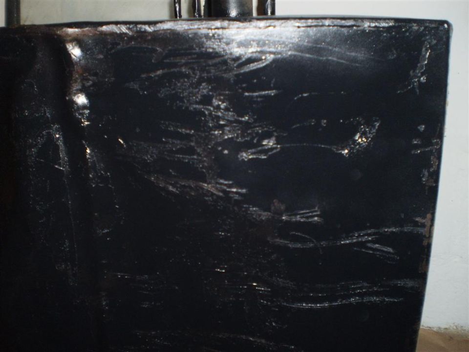 Scratched black painted metal part