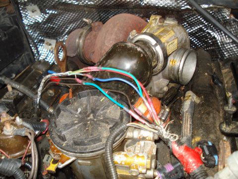1994 Ford F-350 - Close-up view of a turbocharger and associated engine parts with visible wiring.