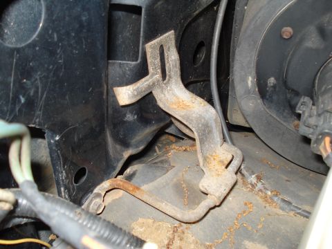 1994 Ford F-350 - A close-up view of a corroded metal bracket in an engine bay.