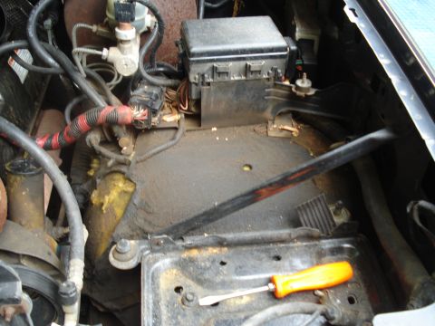 1994 Ford F-350 - Close-up view of a vehicle's engine bay, focusing on the electrical components and battery area.