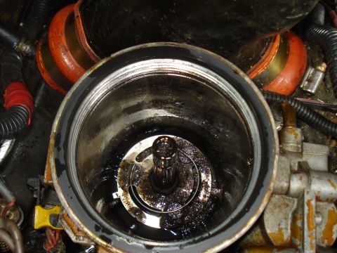 1994 Ford F-350 - The inside of a dirty engine oil filter housing is shown, with visible oil and grime.