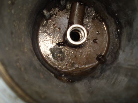 1994 Ford F-350 - Dirty engine oil filter housing with a metal fitting visible.